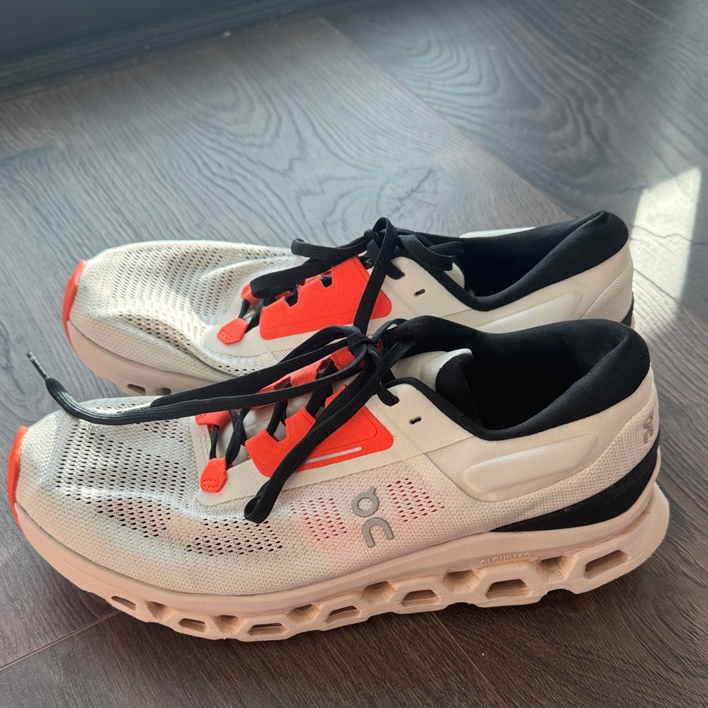 On Running Men's White Sneakers with Orange Accents and Black Laces